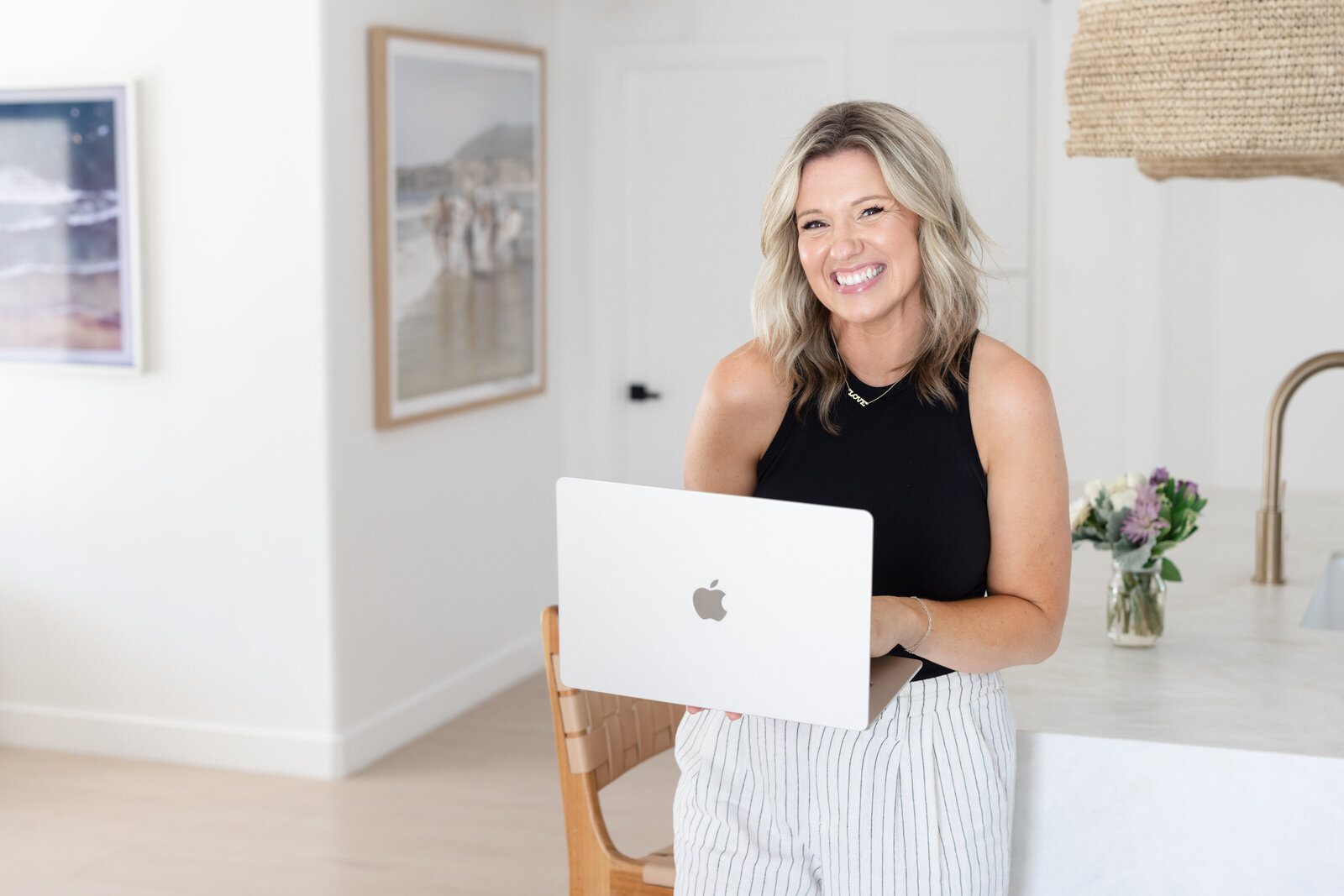 A smiling woman working at a laptop